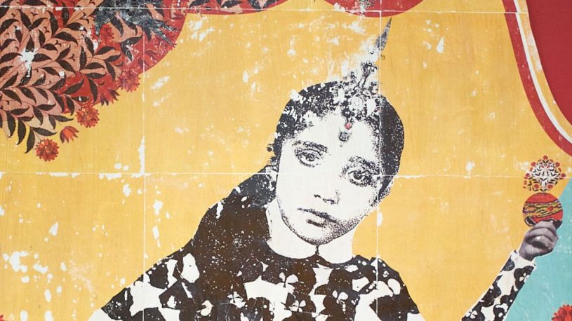 Printed in weathered black & white on a yellow background, a woman holds up a stylised apple
